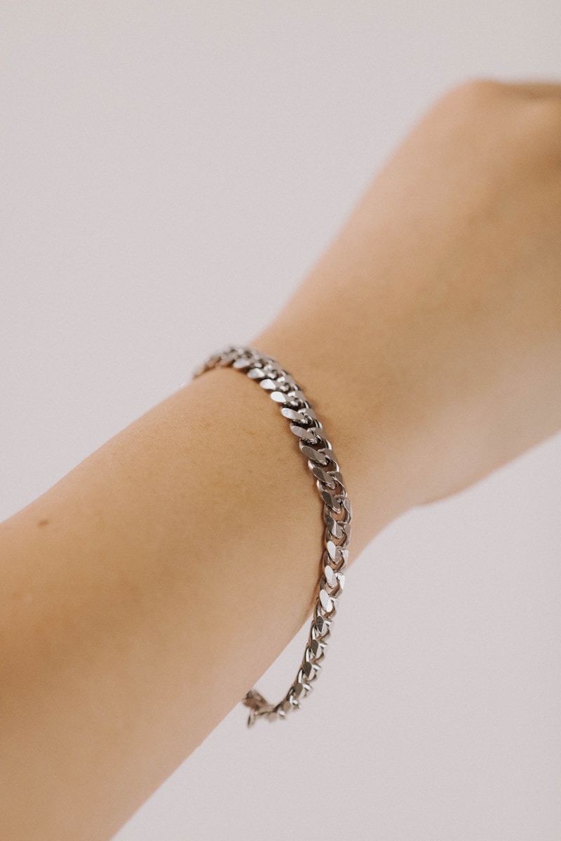 Photo by Oscar Ramirez a woman's arm with a silver bracelet on it